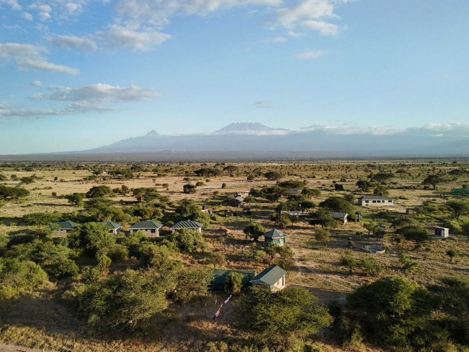 Aerial drone view of Amboseli Ecosystem Trust Noonkotiak headquarters and Mount Kilimanjaro